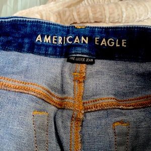 Slightly distressed luxe jegging in a medium wash. Size 12 long